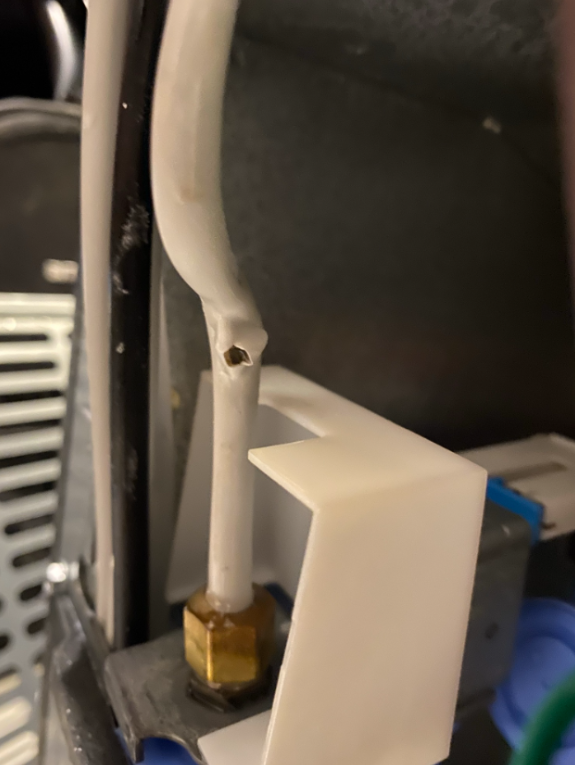 A white rubber or plastic tube with a hole slightly smaller than a pea.