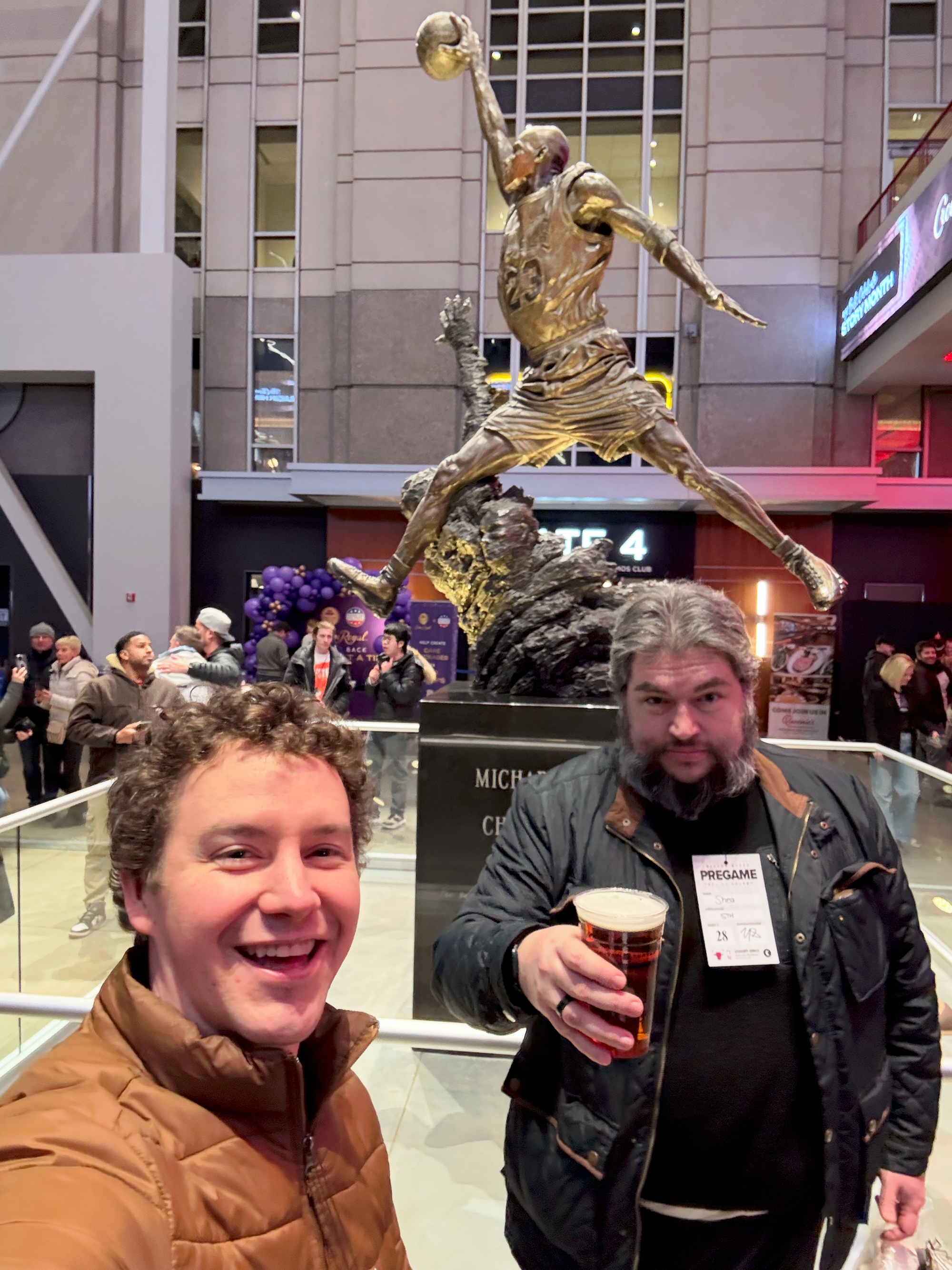 A photo of Rob and Patrick in front of a Michael Jordan statue.