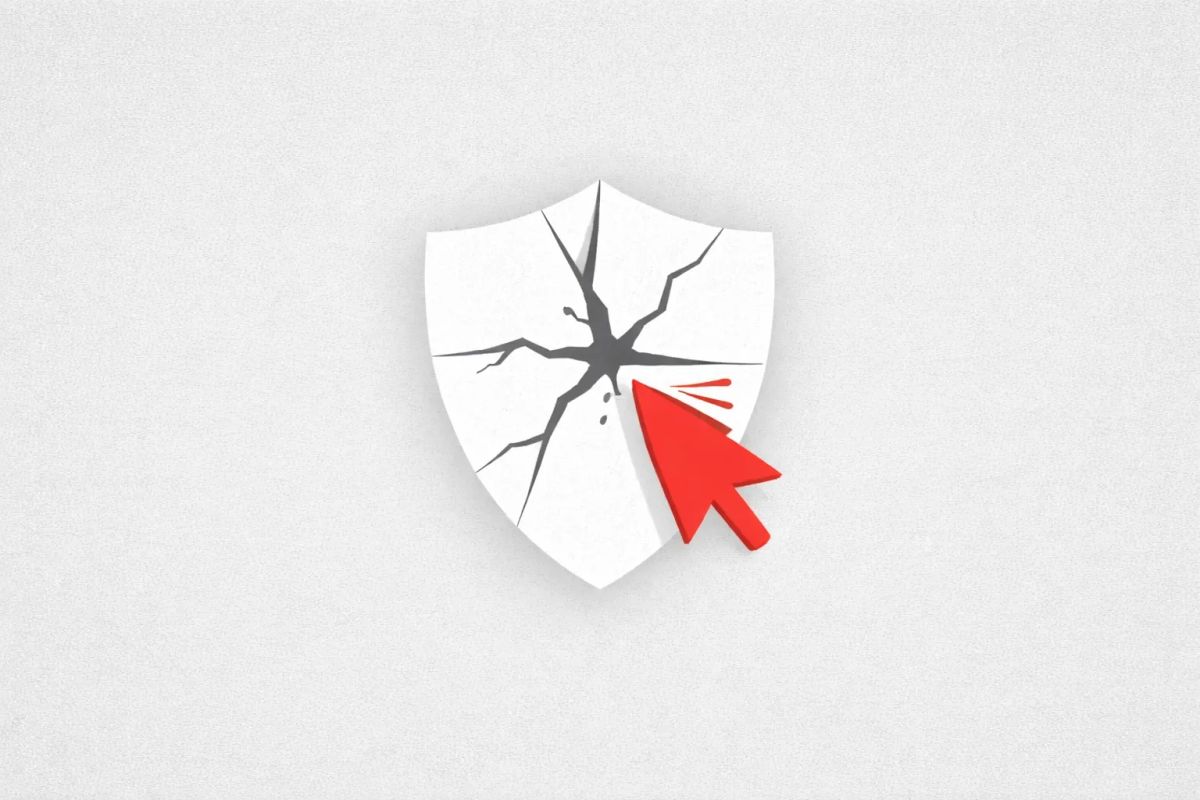 Minimalist vector art of a cracked shield on a gray background, representing the Microsoft Defender zero-day leaks.
