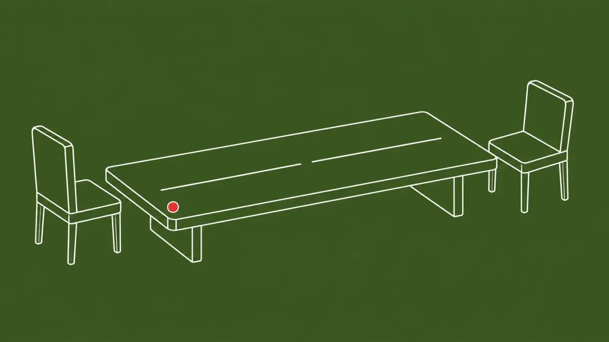 Flat white line-art of a long negotiation table split by a broken center line, one chair at each end — a former ransomware negotiator sentenced to prison.