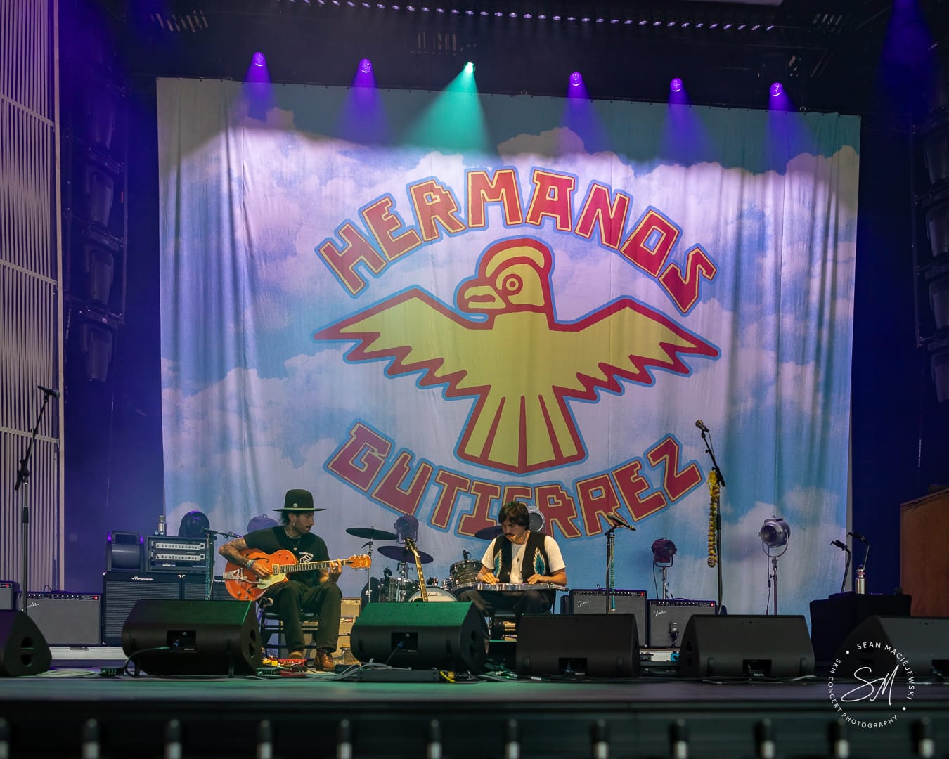Hermanos Gutiérrez performing on stage, with the two band members playing the guitar and drums