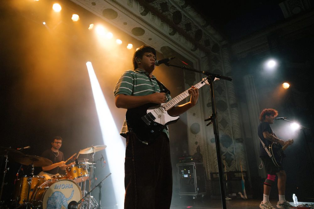 The lead singer of INOHA in front of band members. 