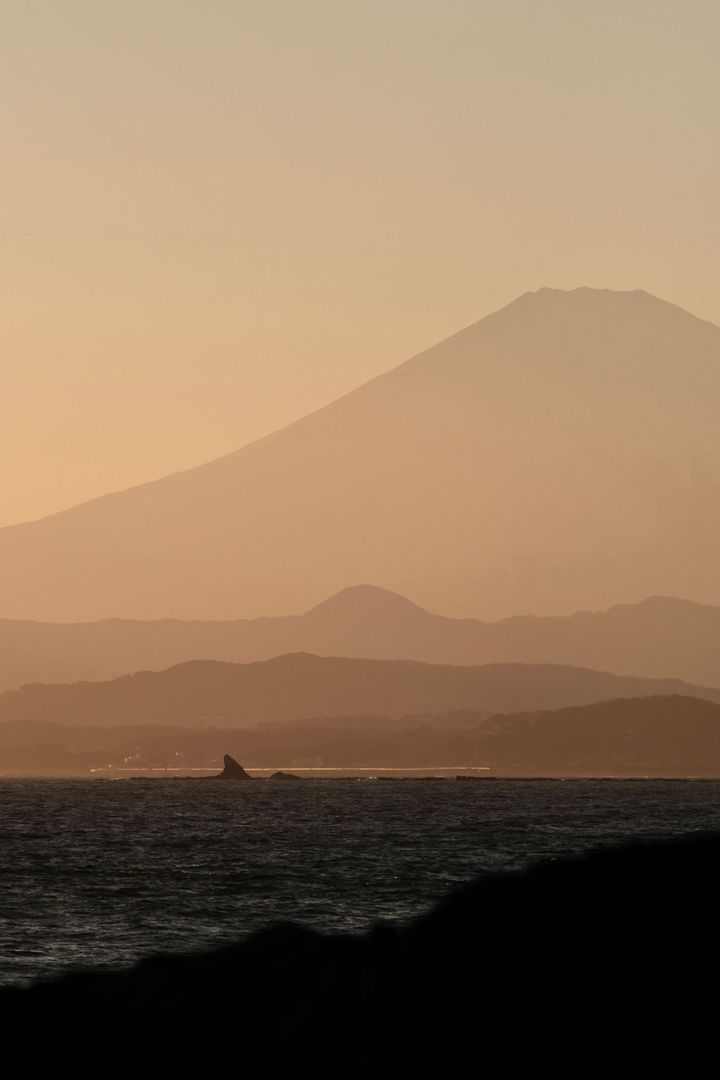Mount Fuji in front of the ocean at sunset