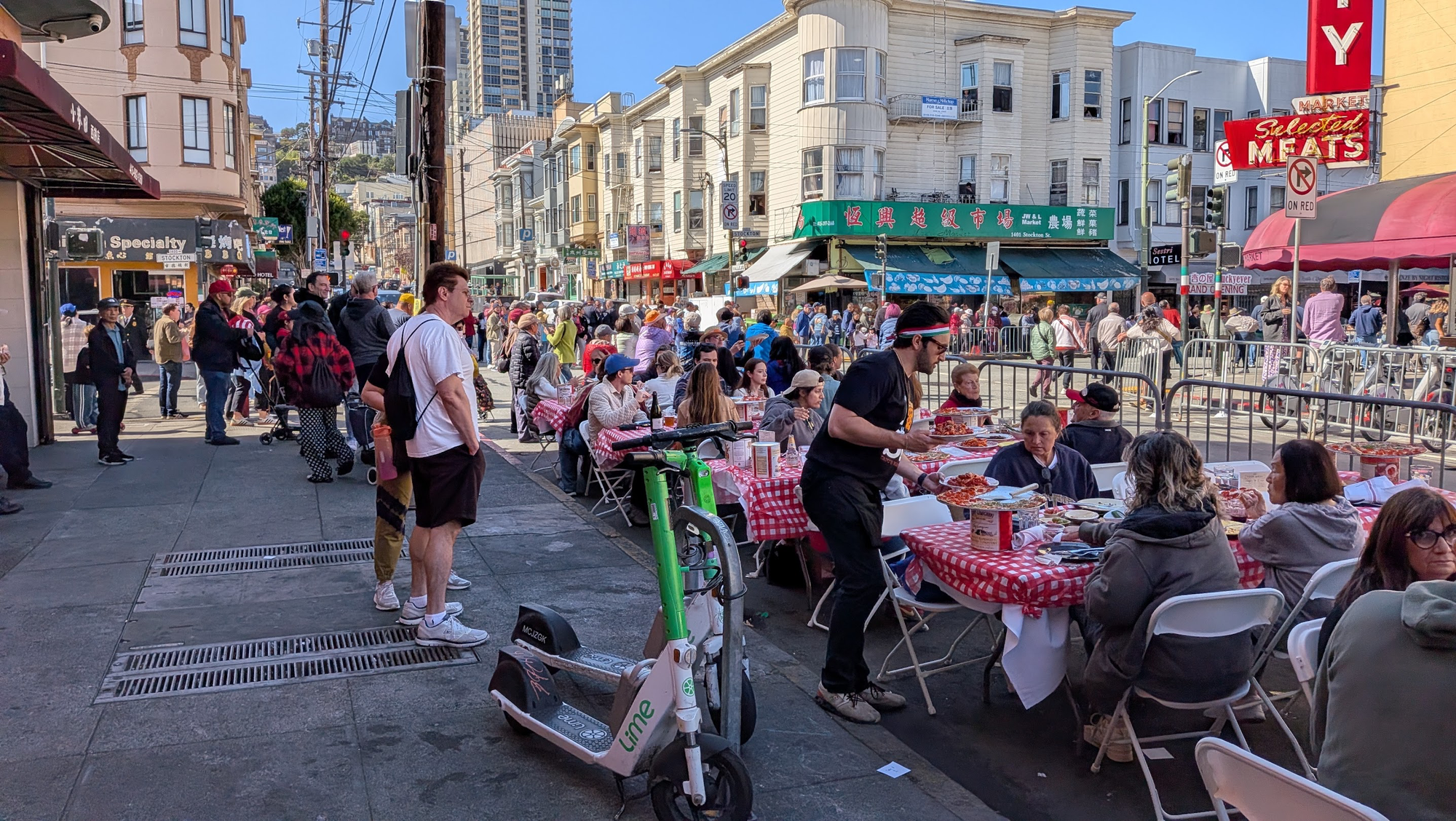 People sat on the side of the road eating