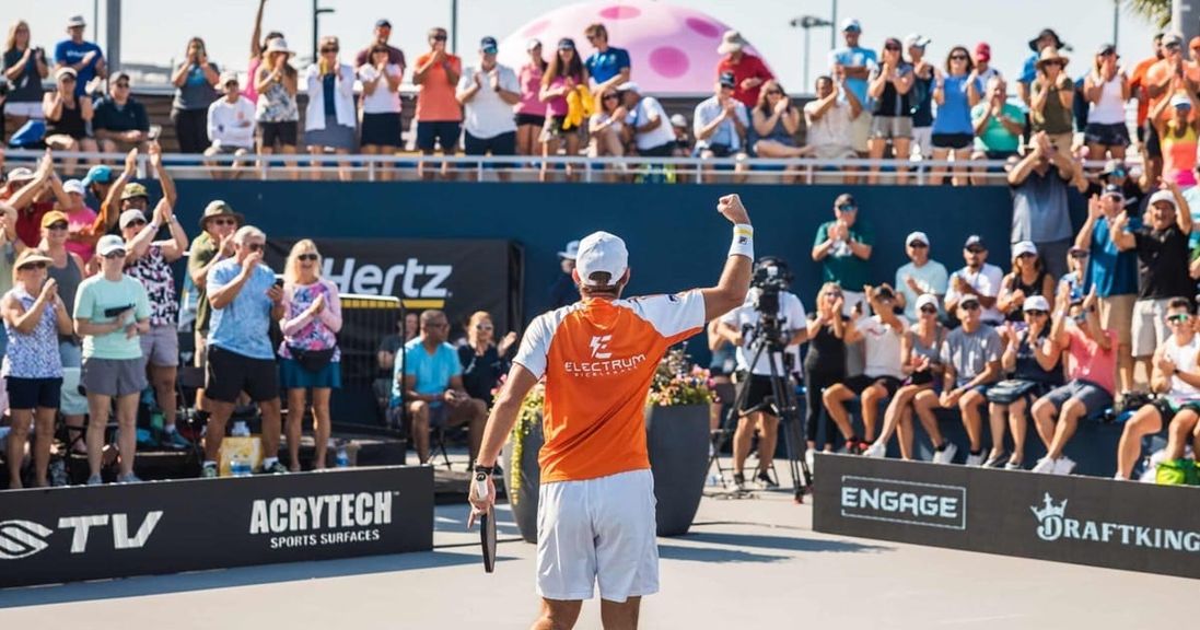 
                                        A pickleball player stands victorious after a win during a PPA Tour event.
                                    