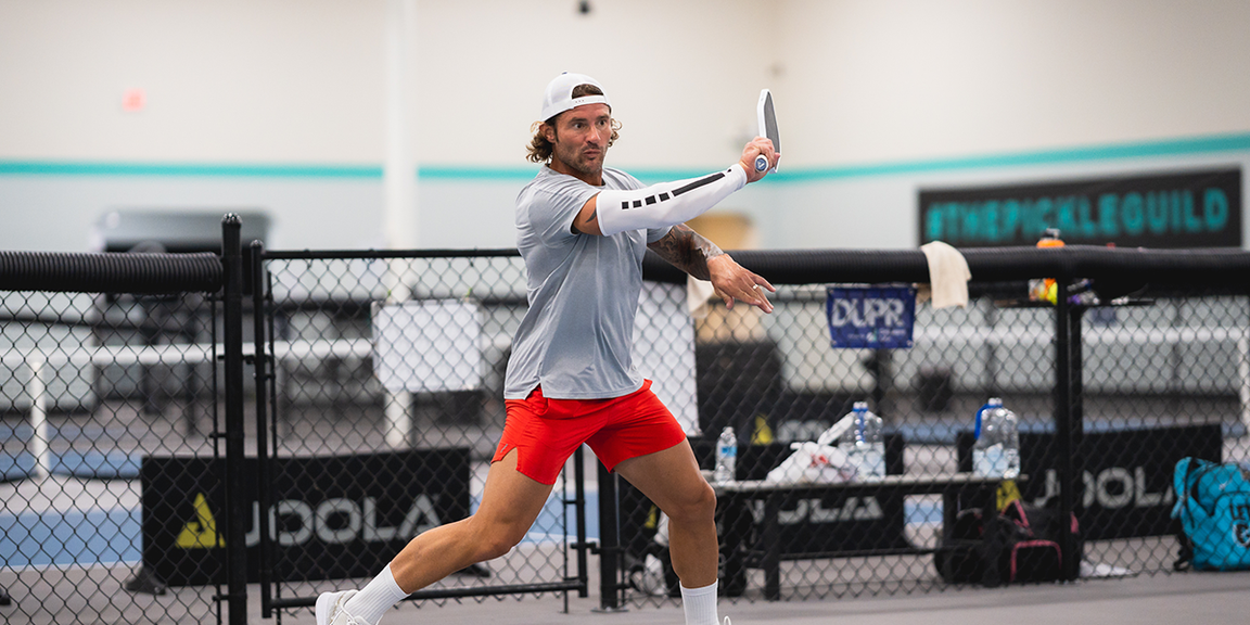 
                                        pickleball player serving
                                    