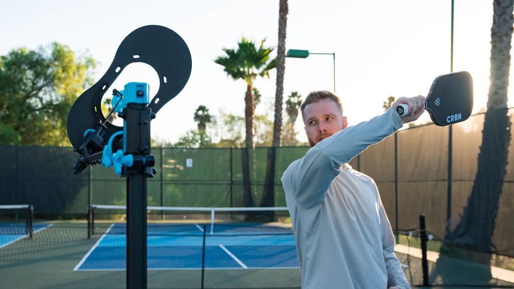 
                                        Man hitting a pickleball with tonspin
                                    