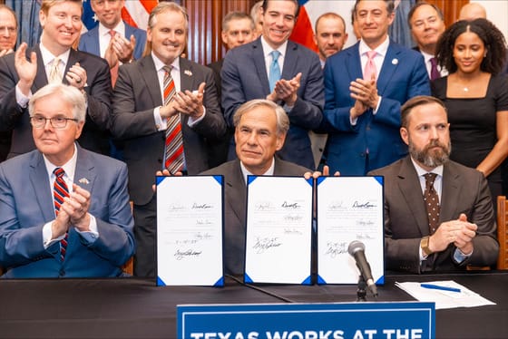 Photo of a bill signing ceremony with state officials.