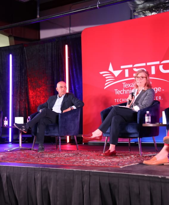 Two panelists on stage during a recent presentation.