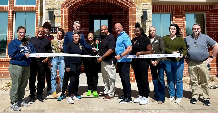 Photo of a ribbon cutting.