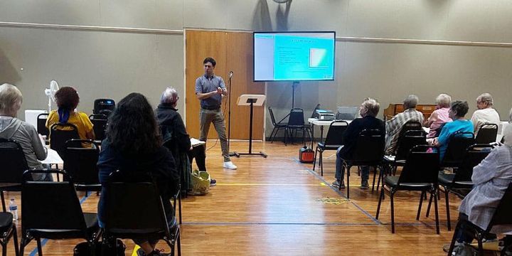 Photo of conference attendees listening to a presentation.