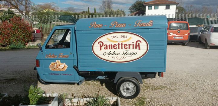 A photo of a Piaggio Ape, a three-wheeled truck made in Italy.