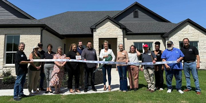 Photo of a ribbon cutting.