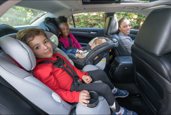 An image of several children in their car seats.
