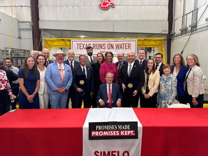 Photo of a bill signing.
