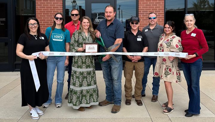 A ribbon cutting photo.