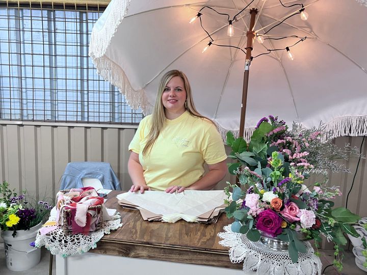 Photo of a farmers market vendor selling flowers.