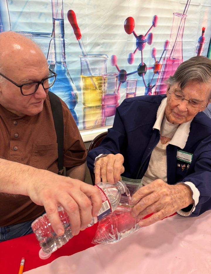 Photo of two people doing a science experiment.
