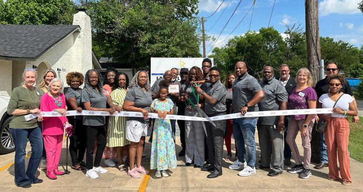 Photo of a ribbon cutting.