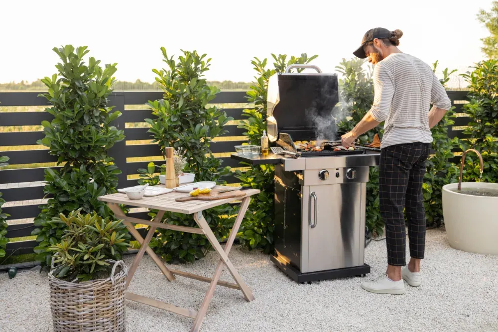 man using a grill at an Airbnb