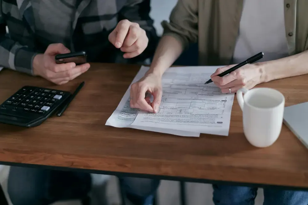 young couple adding up costs to price an airbnb