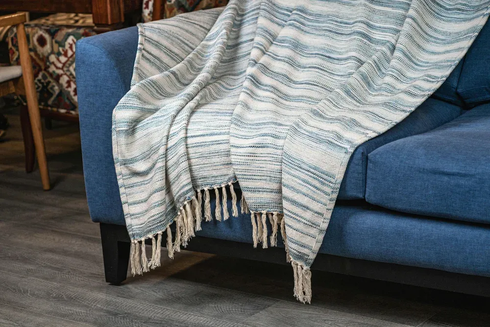 throw blanket on a couch in an airbnb