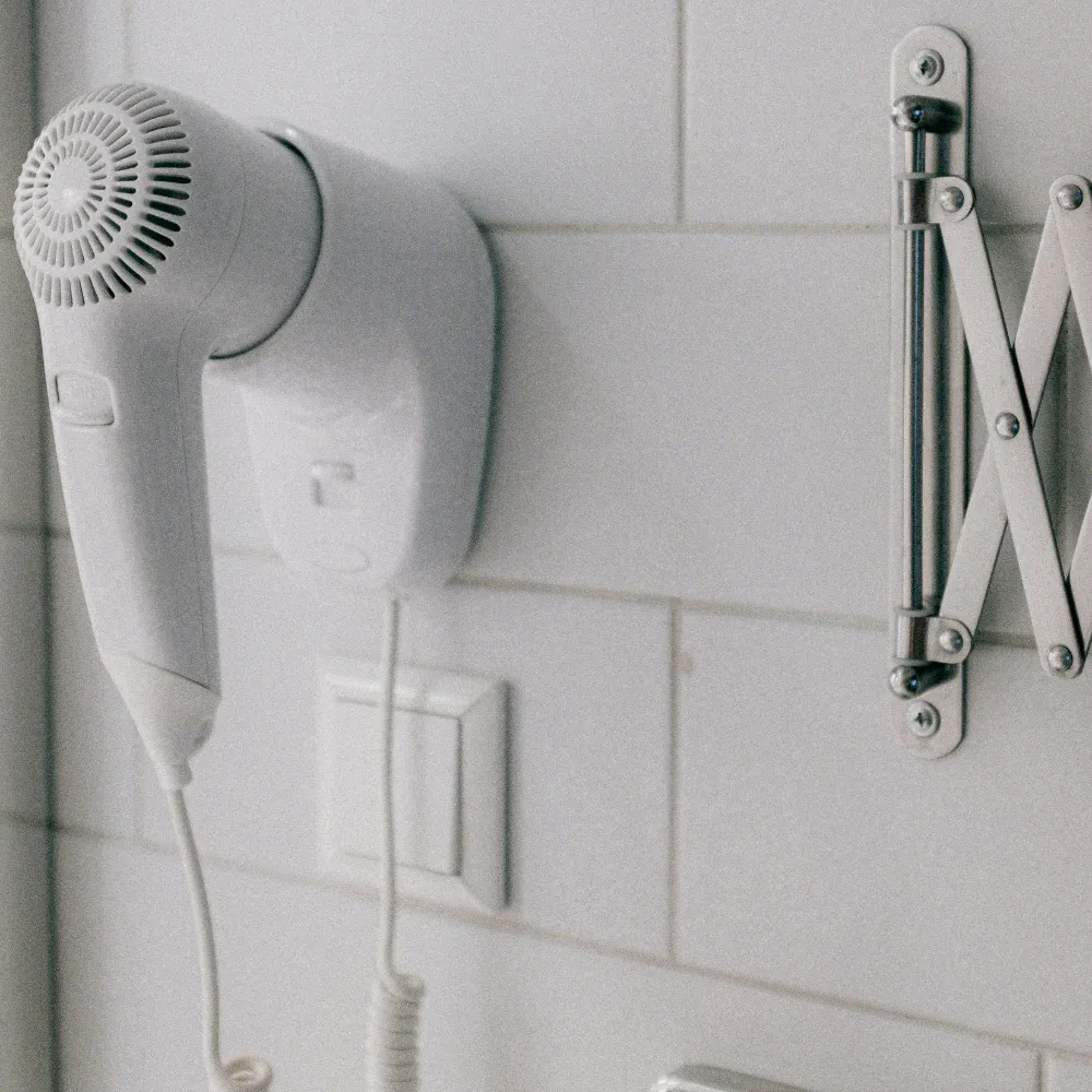 wall-mounted hair dryer in airbnb or rental property