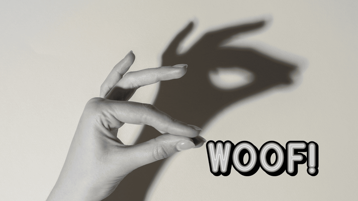 hand doing a shadow puppet of a dog and the word "woof!"