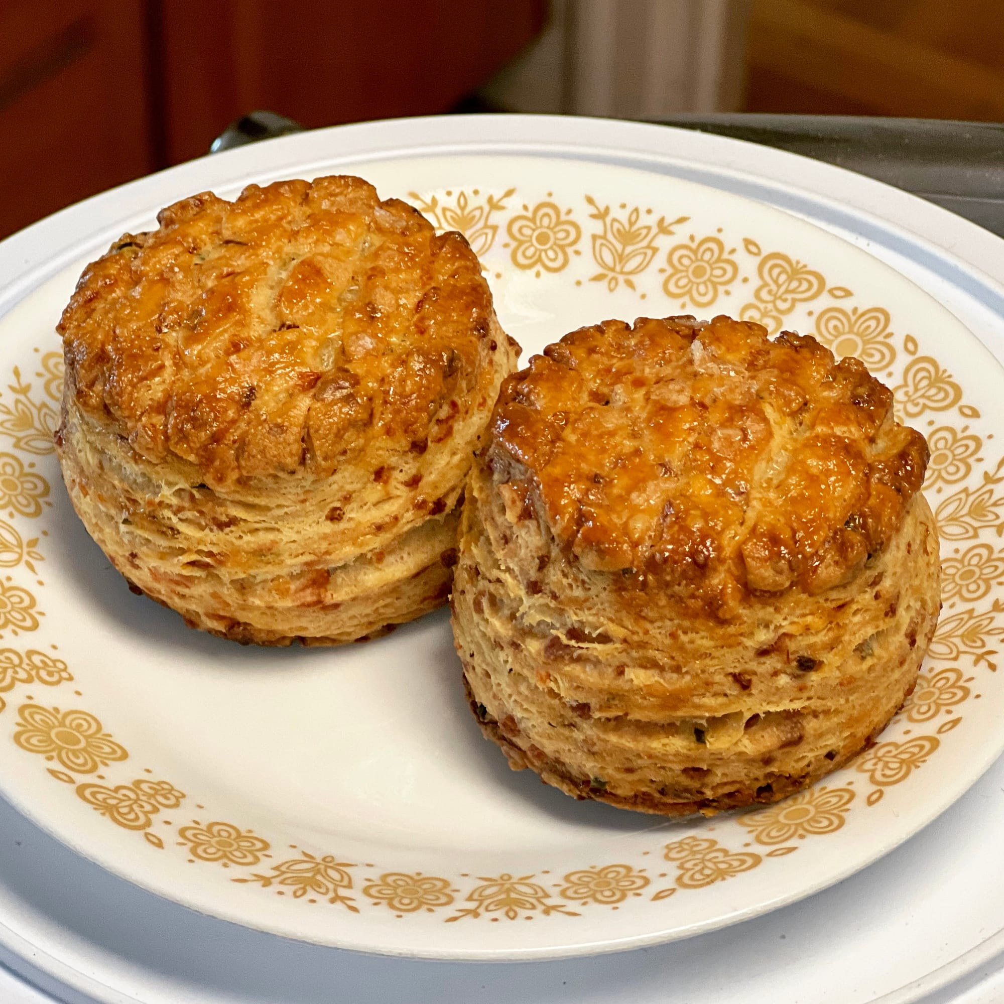 Two round, golden brown biscuits are on a plate.