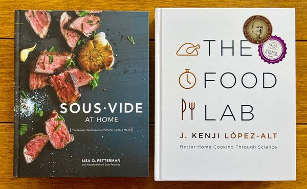 Two cookbooks, Sous Vide at Home by Lisa Fetterman, and The Food Lab by J. Kenji Lopez-Alt