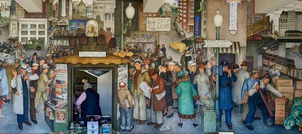 A wall has a painted scene of busy city life in 1930s San Francisco.