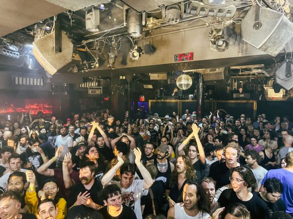 Looking out over a crowd of sweaty punks. a disco ball in the background.