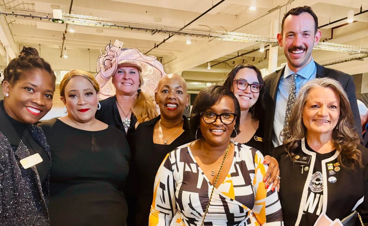 Eight people stand together for a photo at IBEW Local 68 before the Labor Hall of Honor Dinner.