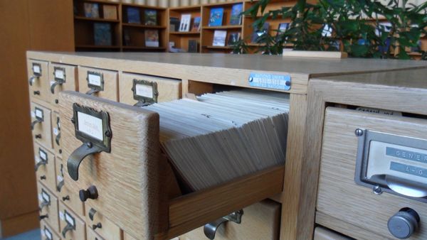 An open drawer of index cards in a wooden card catalogue at the library of the United Nations Office at Geneva