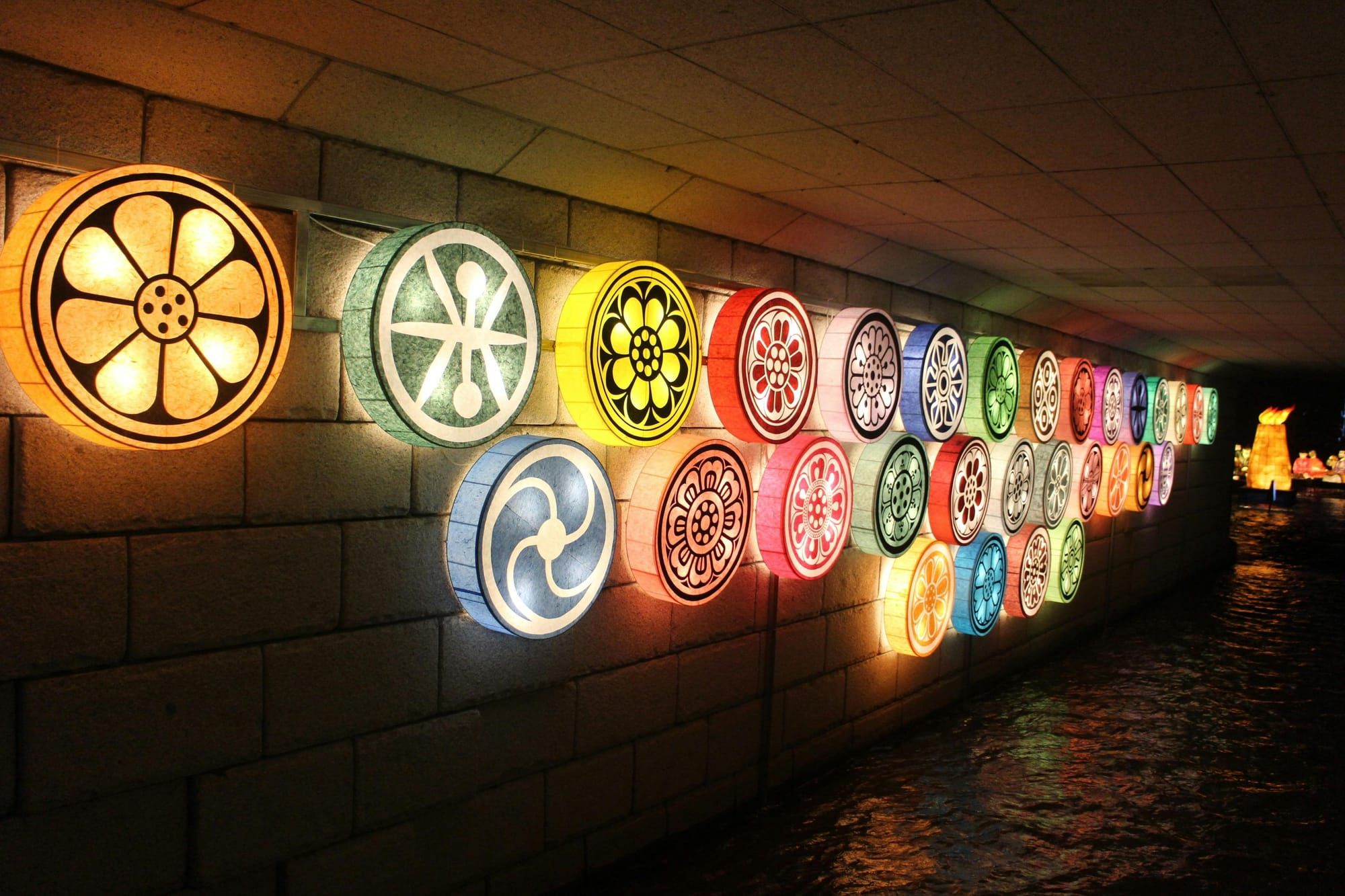Disc-shaped lanterns with designs on the flat side.
