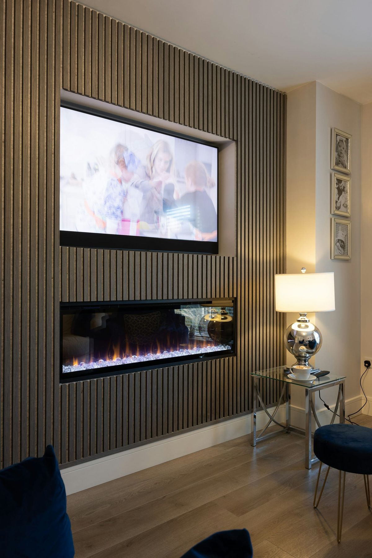 Flat-screen TV mounted above a fireplace in a modern living room with a clean wall and no visible cords