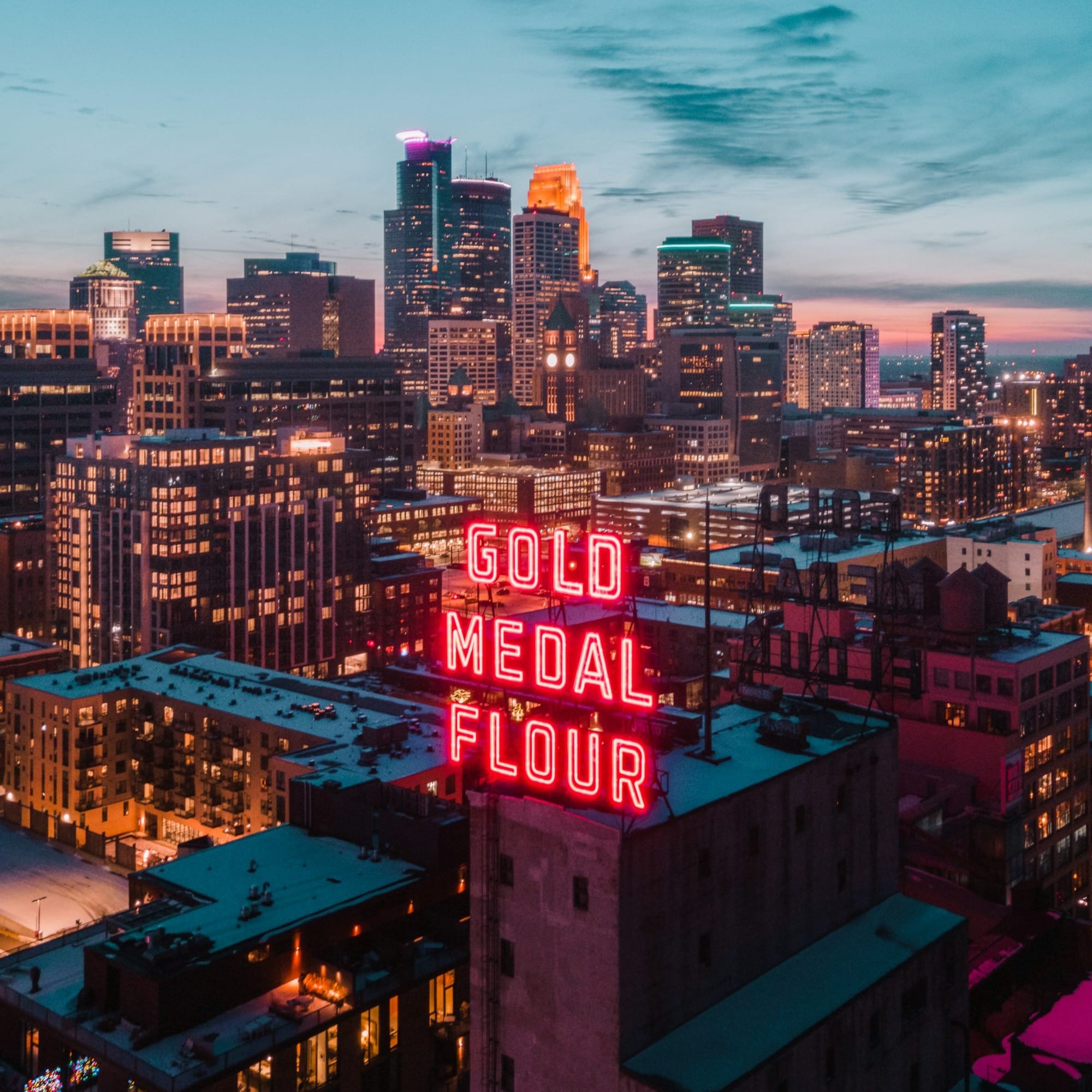 city skyline under blue sky during night time