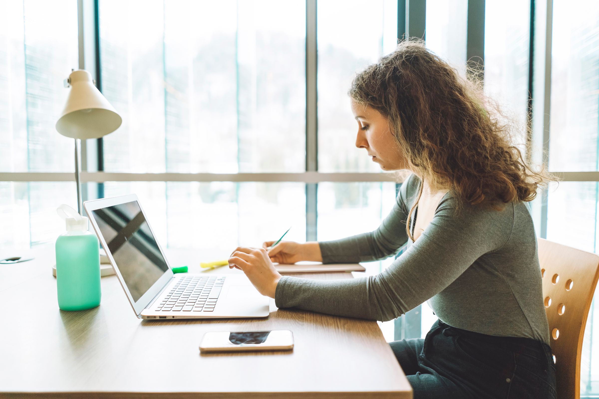 woman using a laptop - Personal Statement for College