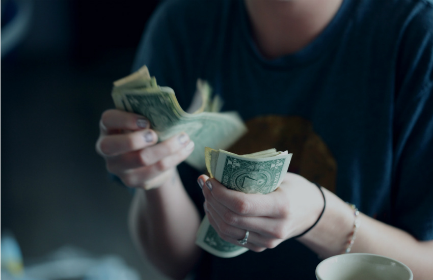 woman counting money - College Application Essay 