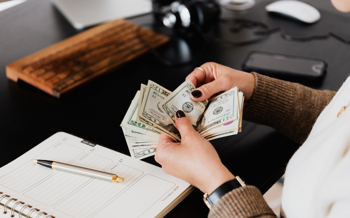 student counting money - Dorm Room Essentials