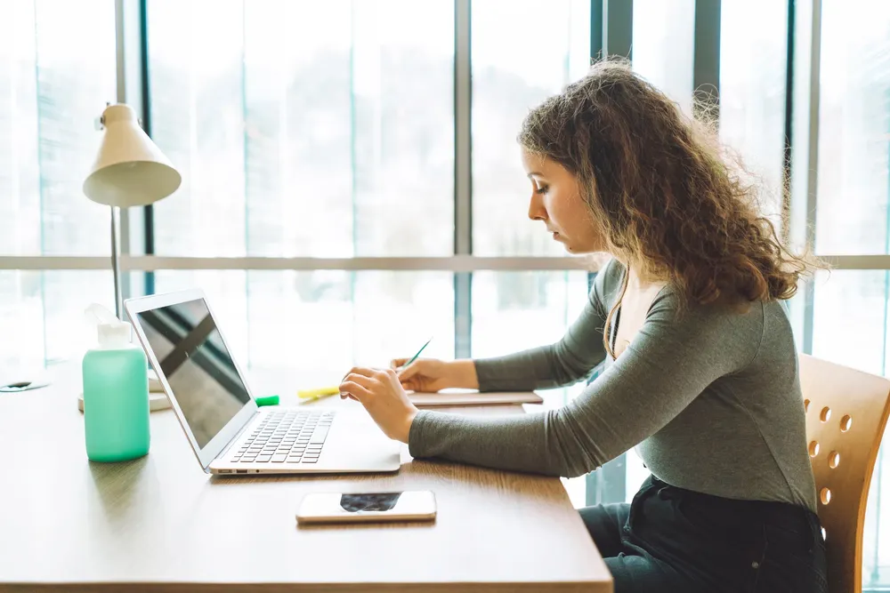 woman using a laptop - Personal Statement for College