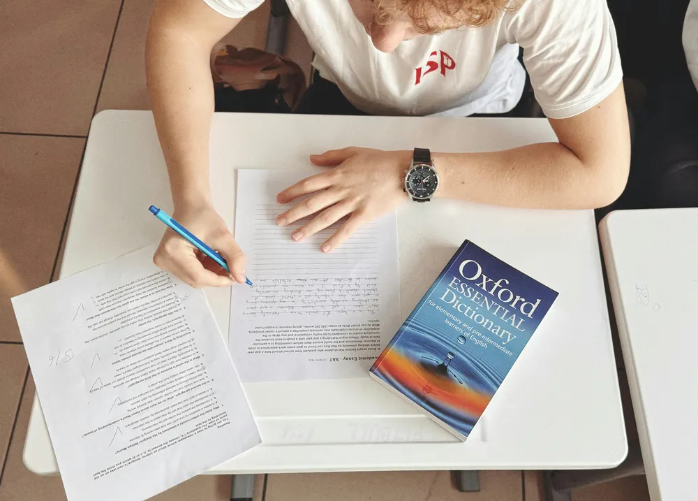 student writing a paper - PIQ Questions