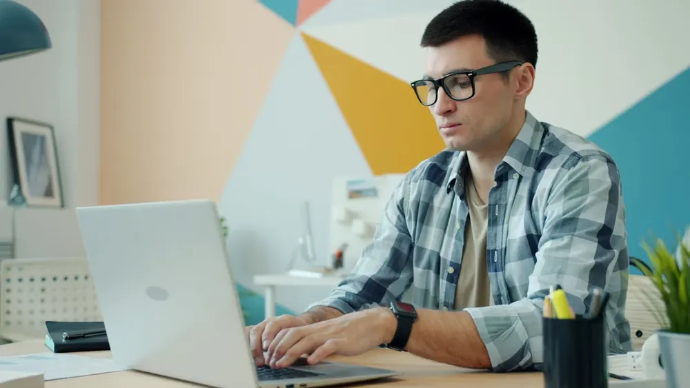 man typing - Common App Essay Prompts