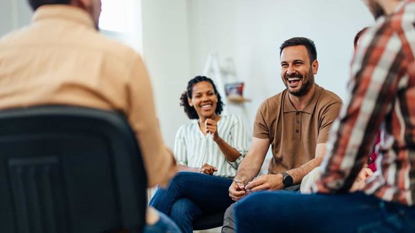 Support group of people talking and smiling