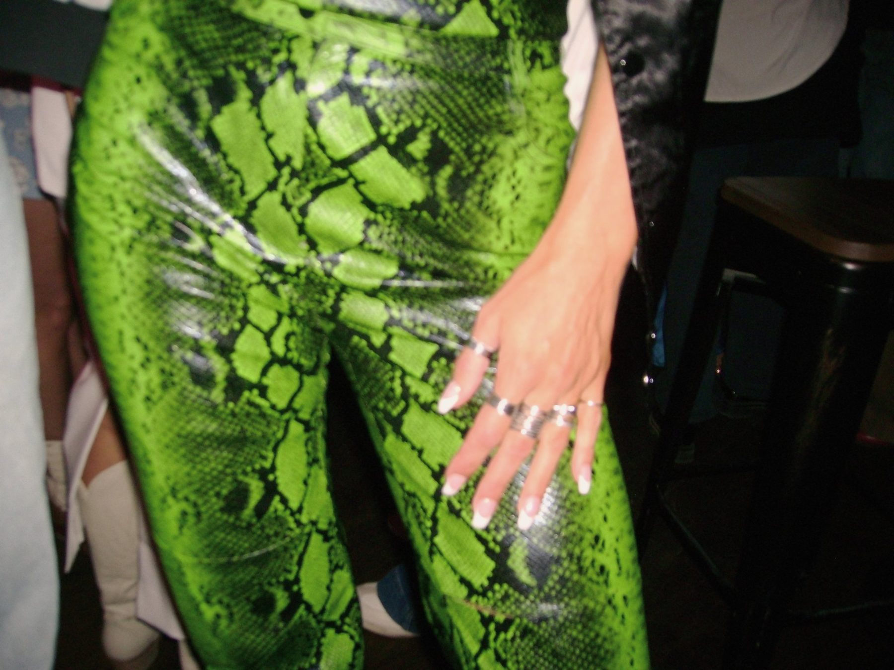 From Kara Hobby’s Wilson Mom summer: neon green snakeskin trousers and a ringed hand