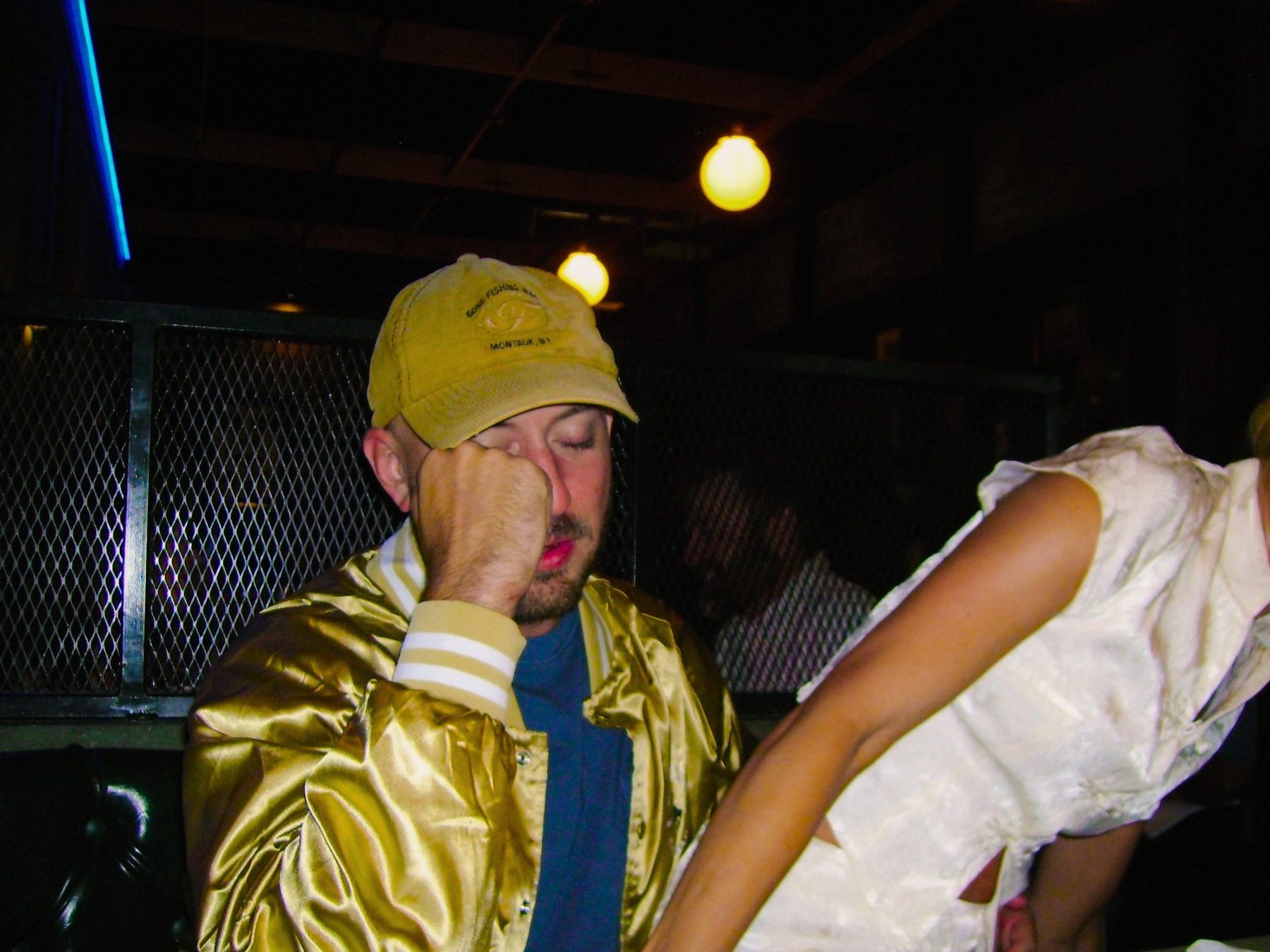 From Kara Hobby’s Wilson Mom summer: man in a gold satin jacket at a bar