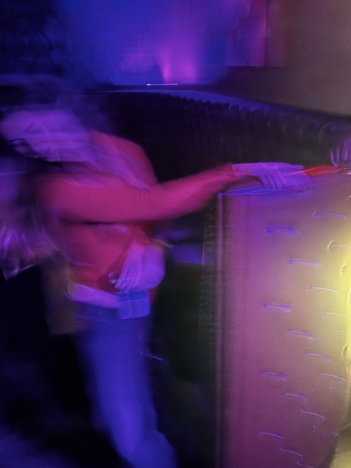 From Kara Hobby’s Wilson Mom summer: motion-blurred dancer in purple club light