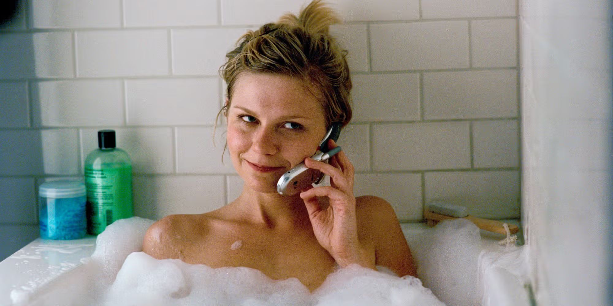 Kirsten Dunst in a scene from 'Elizabethtown.' She is in a bubble bath with her blonde hair up while on a cell phone.