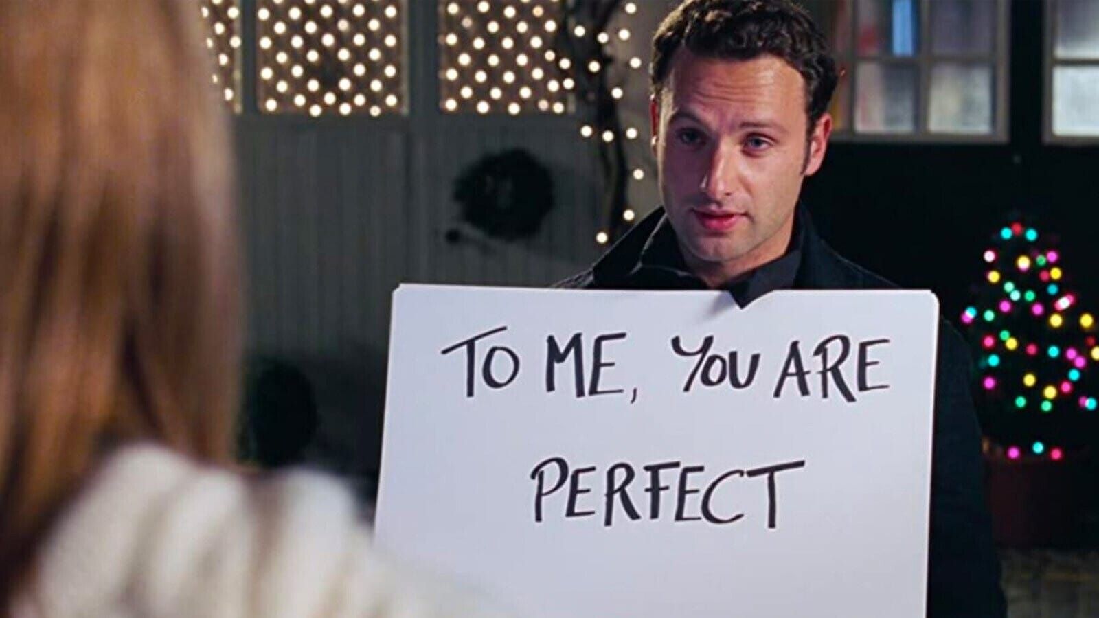 Image of Andrew Lincoln holding up a cue card that says "To me, you are perfect" in 'Love, Actually'