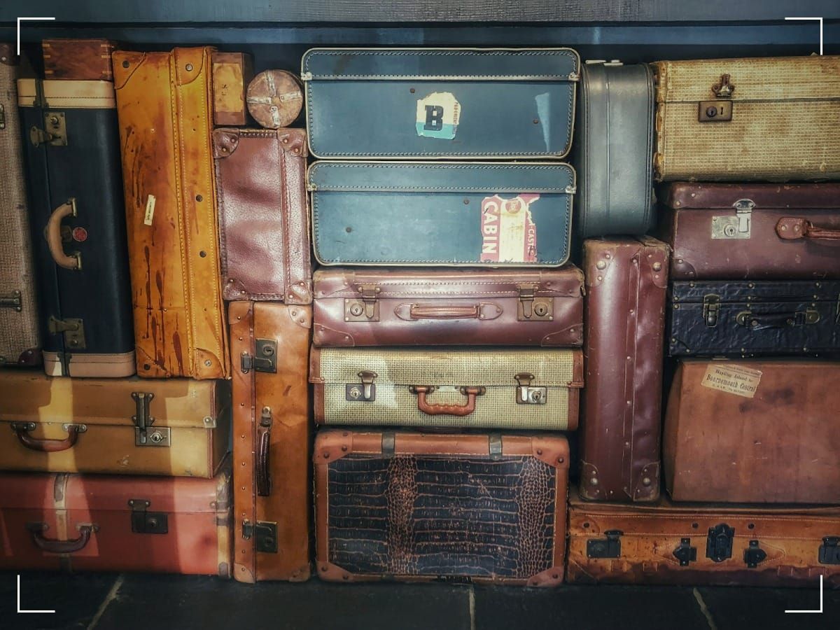 Old suitcases piled up on top of eachother.